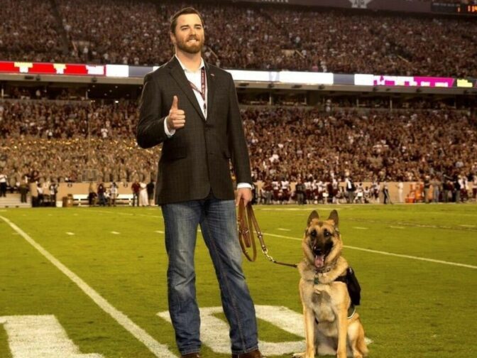 Veteran Cole Lyle poses with his late service dog, Kaya, at Kyle Field, the Texas A&M football stadium.