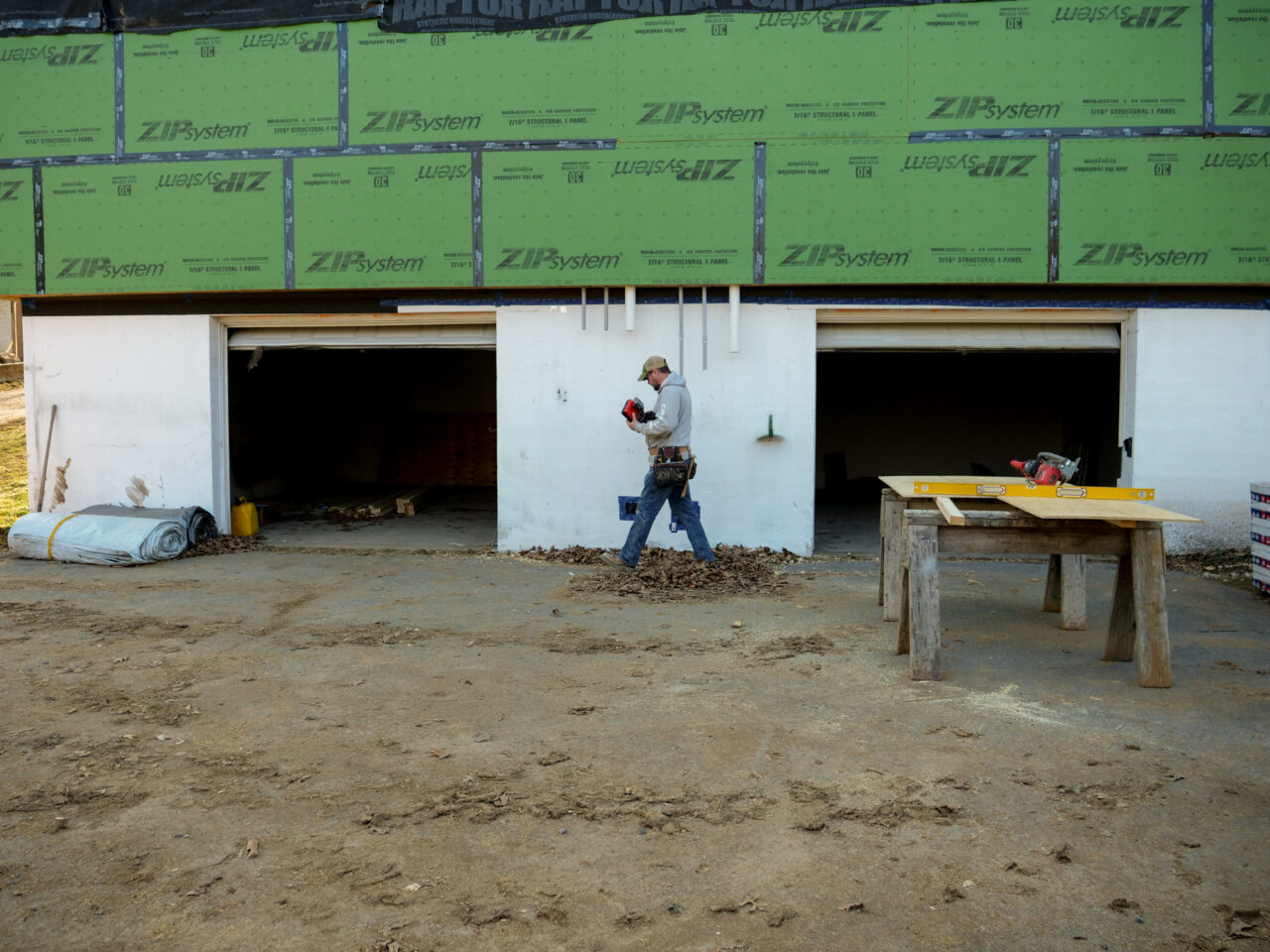 Zach Tingle, a carpenter with Envinity, works at a home in State College