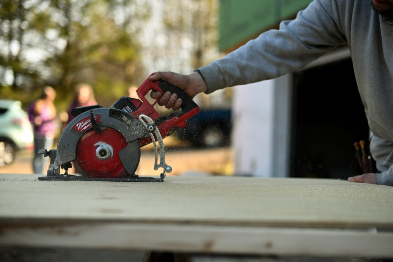 Zach Tingle, a carpenter with Envinity, works at a home in State College