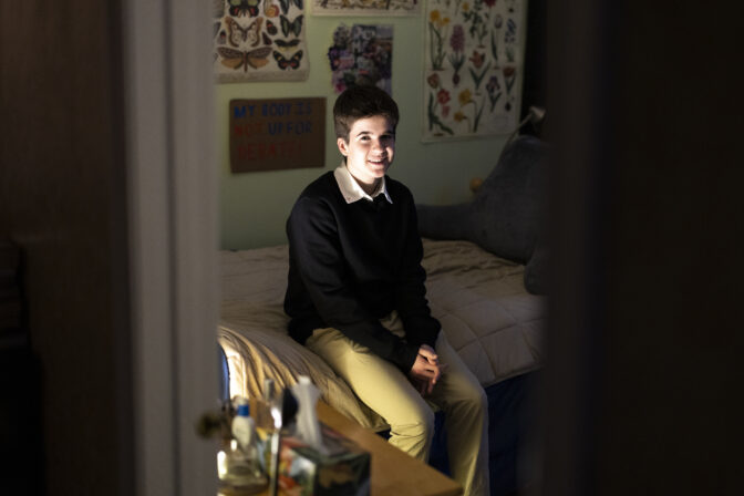 Central Bucks School District high school student Leo Burchell sits for a portrait in his bedroom in Pennsylvania, Tuesday, Nov. 15, 2022. Over the last year, the Central Bucks School District’s board barred staff from using students’ chosen names or pronouns without parental permission.