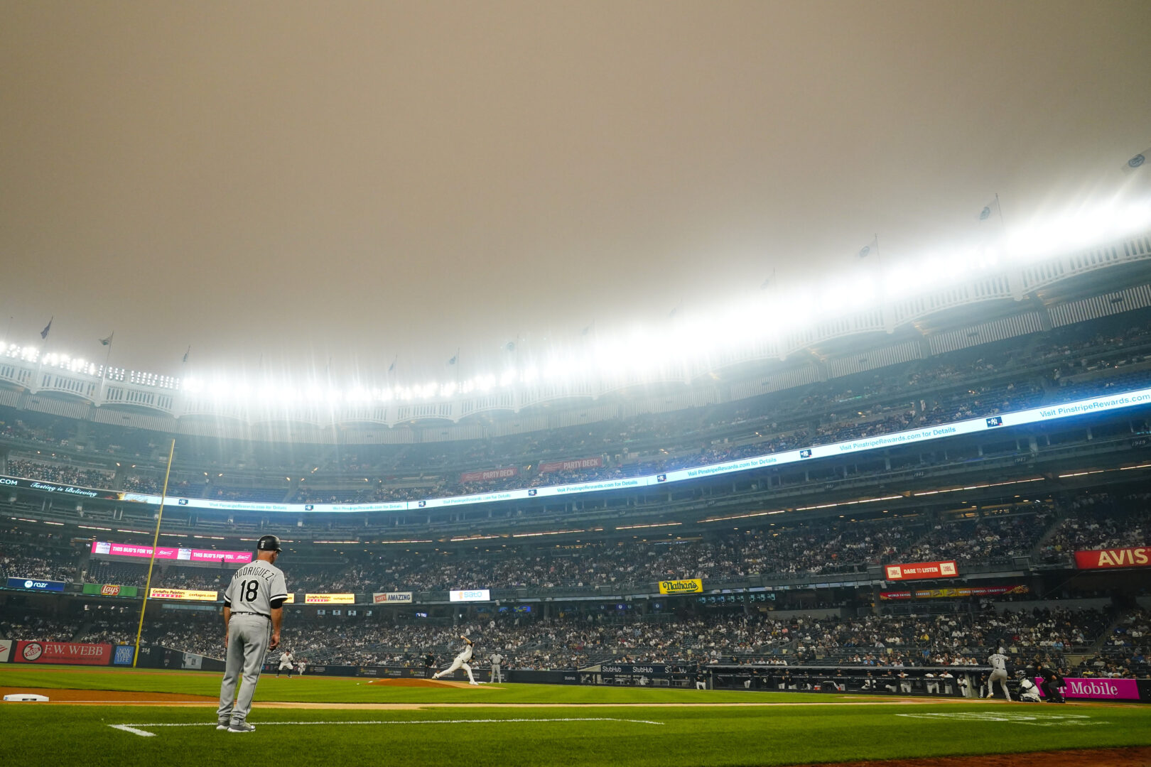 New York Yankees' Clarke Schmidt pitches to Chicago White Sox's Tim Anderson during the first inning of a baseball game Tuesday, June 6, 2023, in New York. Smoke from Canadian wildfires has traveled into the United States, resulting in a number of air quality alerts issued since May. (AP Photo/Frank Franklin II)