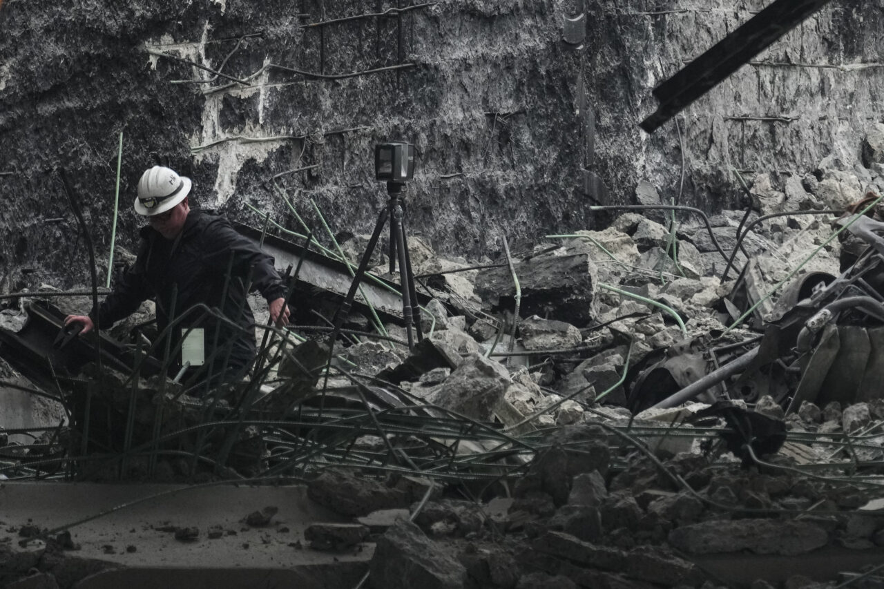 A investigator surveys the aftermath of an elevated section of Interstate-95 that collapsed, in Philadelphia, Monday, June 12, 2023.