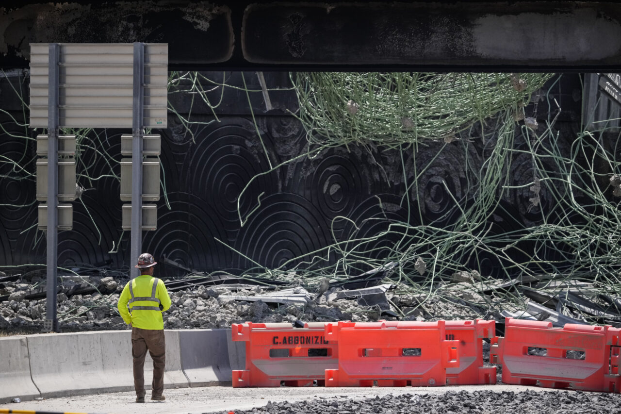 A person views the scene of a collapsed elevated section of Interstate 95, Tuesday, June 13, 2023, in Philadelphia. (AP Photo/Matt Slocum)