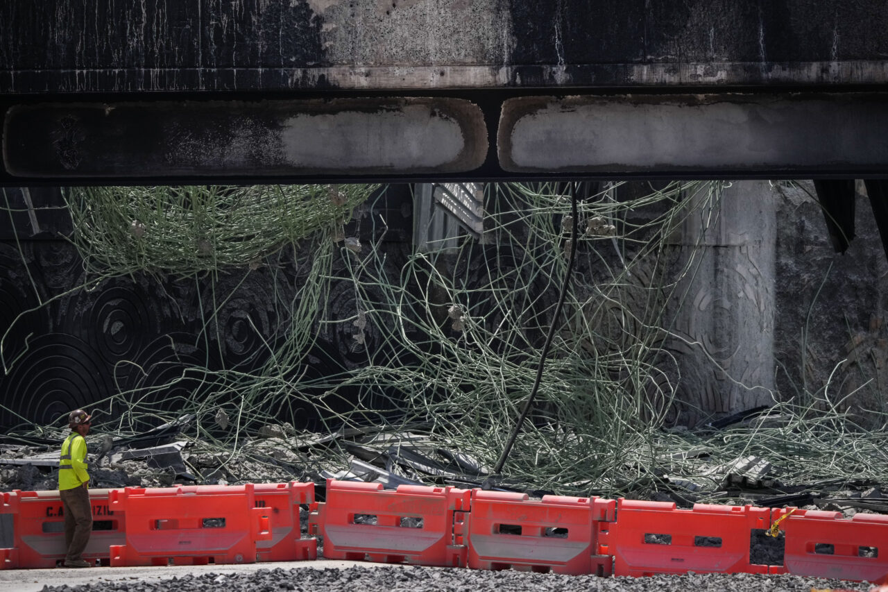 A person views the scene of a collapsed elevated section of Interstate 95, Tuesday, June 13, 2023, in Philadelphia. (AP Photo/Matt Slocum)