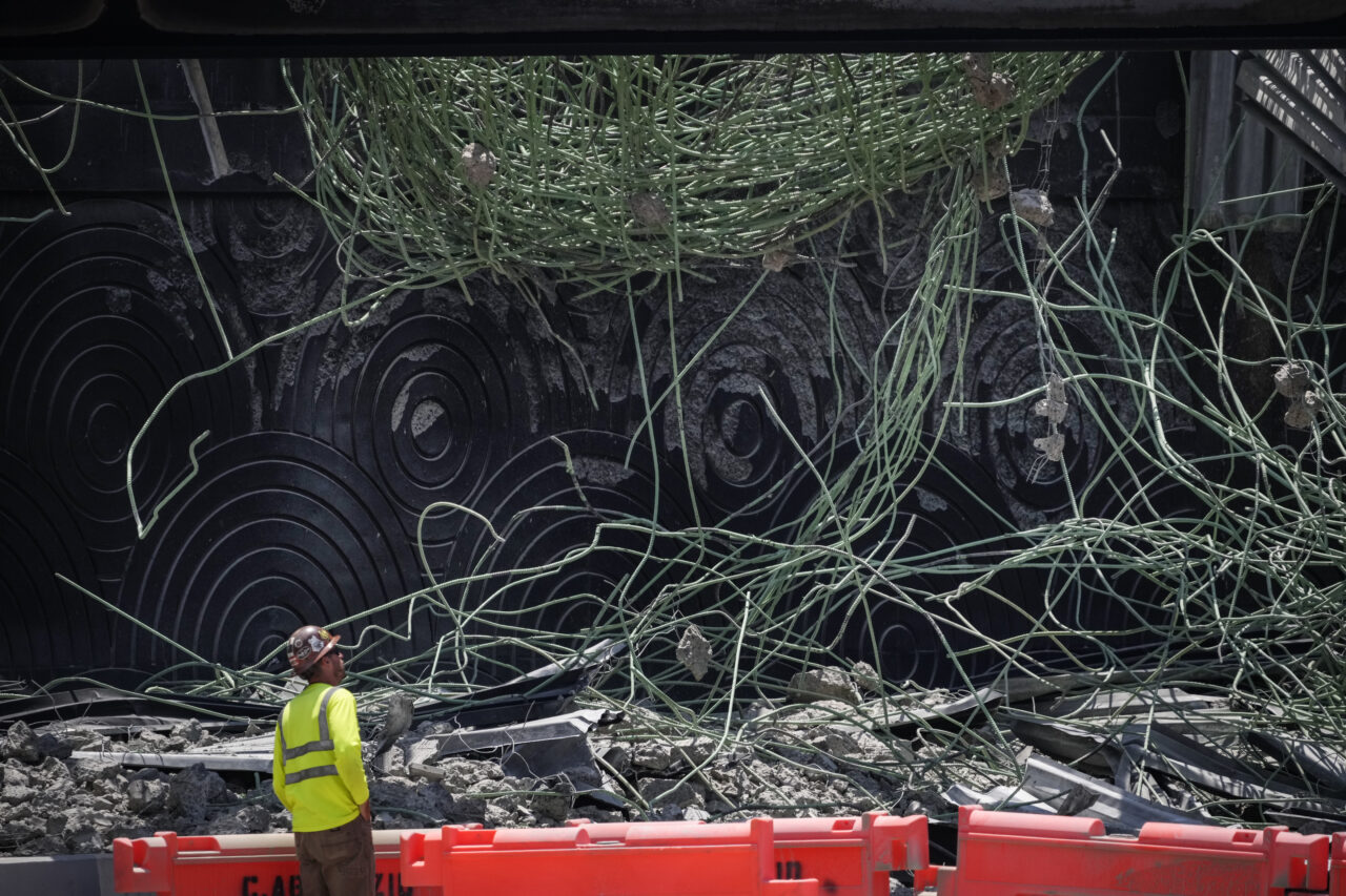 A person views the scene of a collapsed elevated section of Interstate 95, Tuesday, June 13, 2023, in Philadelphia. (AP Photo/Matt Slocum)