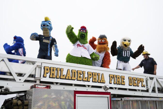 Mascots from professional Philadelphia sports teams cross over the repaired section of Interstate 95 as the highway is reopened Friday, June 23, 2023 in Philadelphia.