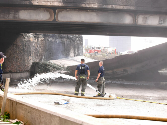 Firefighters work at a collapsed portion of Interstate 95, caused by a large vehicle fire, in Philadelphia, Pennsylvania, on June 11, 2023. A fire caused part of a busy US highway overpass to collapse in Philadelphia early Sunday, authorities said, as reports attributed the accident to an oil tanker that burst into flames under the bridge. The collapse took out four traffic lanes along an elevated section of the heavily traveled motorway, though no injuries were immediately reported. 