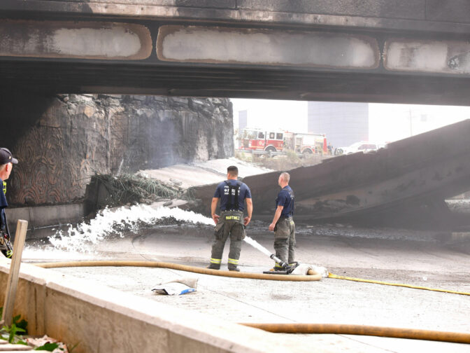 Firefighters work at a collapsed portion of Interstate 95, caused by a large vehicle fire, in Philadelphia, Pennsylvania, on June 11, 2023. A fire caused part of a busy US highway overpass to collapse in Philadelphia early Sunday, authorities said, as reports attributed the accident to an oil tanker that burst into flames under the bridge. The collapse took out four traffic lanes along an elevated section of the heavily traveled motorway, though no injuries were immediately reported. 