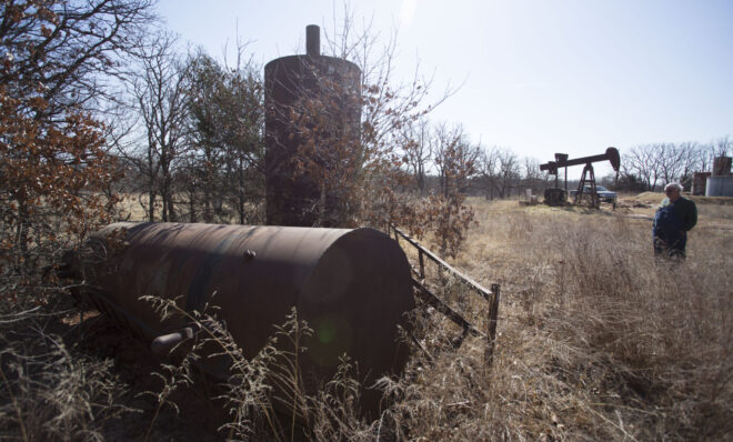 DEPEW, OK - FEBRUARY 18: John Carter looks at old oil field equipment covered by vegetation near his home February 18, 2016 in Depew, Oklahoma. Thousands of abandoned oil wells were never properly mapped and many of the original drilling companies no longer exist. The state is now the earthquake capital of the world and the quakes are believed to be caused by oil field waste water injections into the earth. In 1993, the Oklahoma Energy Resources Board began to restore abandoned oil well sites. Since the program's inception more than $90 million has been spent to restore more than 14,500 abandoned well sites. Officials report the old wells have leaked oil, natural gas and brine into the soil. 