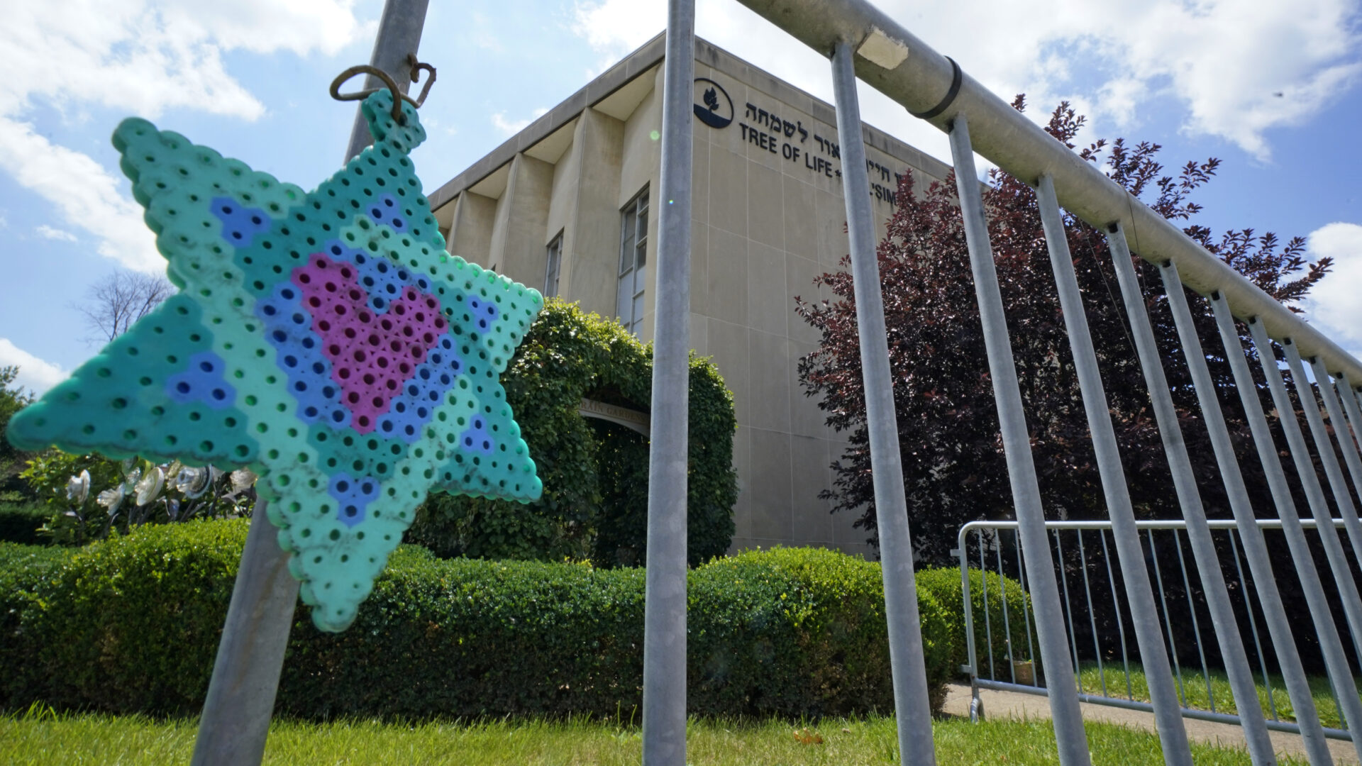 A Star of David hangs from a fence outside the dormant landmark Tree of Life synagogue in Pittsburgh's Squirrel Hill neighborhood on Thursday, July 13, 2023, the day a federal jury announced they had found Robert Bowers, who in 2018 killed 11 people at the synagogue, eligible for the death penalty. 
