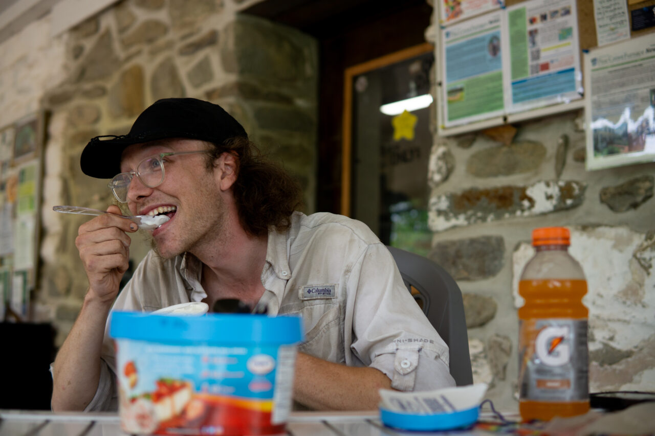 Neil "Happy Feet" Postal, 24, of Virginia Beach, Virginia, an Appalachian Trail through-hiker, takes on the half gallon challenge at the Pine Grove Furnace store on Tuesday, July 18, 2023.