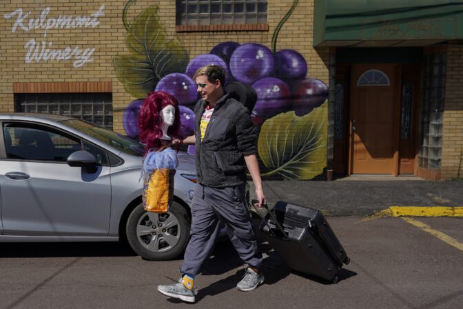 Trixy Valentine, aka Jacob Kelley, brings wigs and a suitcase full of outfits to the car after performing at "Spring Fever Drag Brunch," Sunday, March 26, 2023, at the Kulpmont Winery in Kulpmont, Pa.