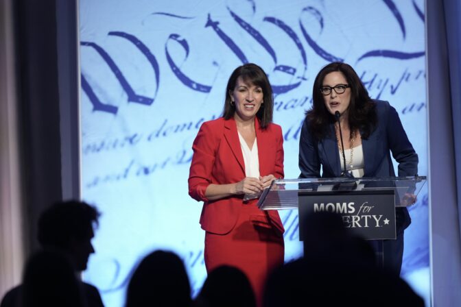 Moms for Liberty founders Tiffany Justice, right, and Tina Descovich speak at the Moms for Liberty meeting in Philadelphia, Friday, June 30, 2023.