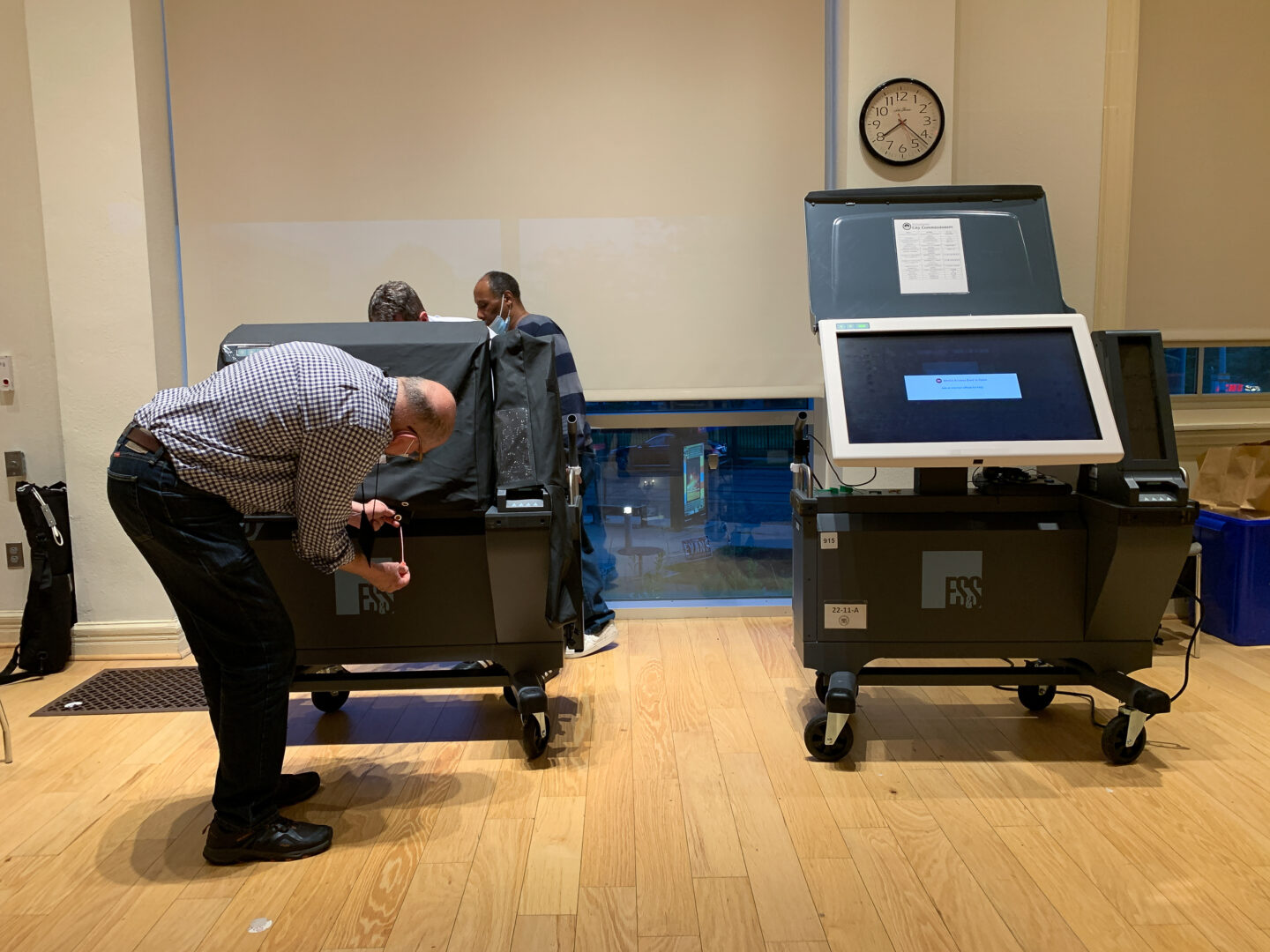 Election workers close down the voting machines in a step by step process.