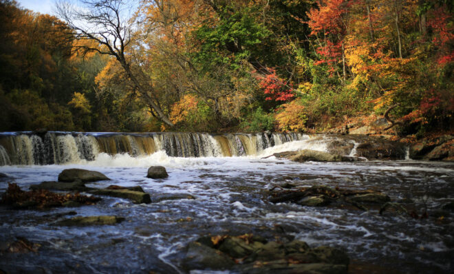 Water flows down the Wissahickon Creek in view of the Autumn foliage Thursday, Oct. 29, 2015, in Philadelphia. (AP Photo/Matt Rourke)