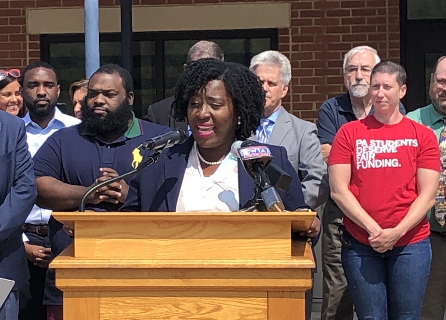 Democratic House Speaker Joanna McClinton stands in front of a podium at the Bald Eagle Area School District as part of a rally to advocate for public school funding.
