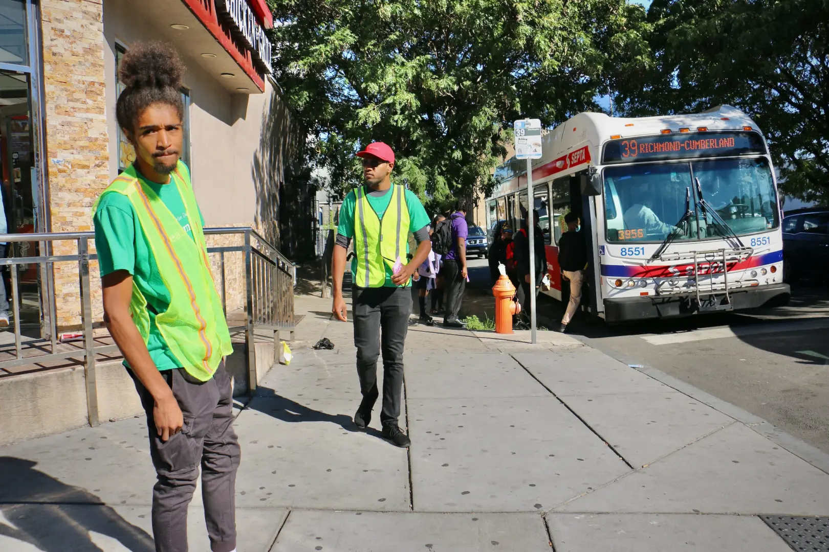 Robert Lynch, 24, (left) and Paul T. Jackson, 34, patrol the corner of Broad and Susquehanna streets, a convergence point for teens when three nearby schools dismiss for the day. 