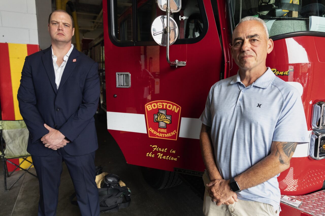 Boston firefighter Daniel Ranahan, left, and retired Brockton deputy fire chief Joe Marchetti pose at the Engine 28 fire station, Friday, July 14, 2023, in the Jamaica Plain neighborhood of Boston. Both Ranahan and Marchetti are cancer survivors. (AP Photo/Michael Dwyer)