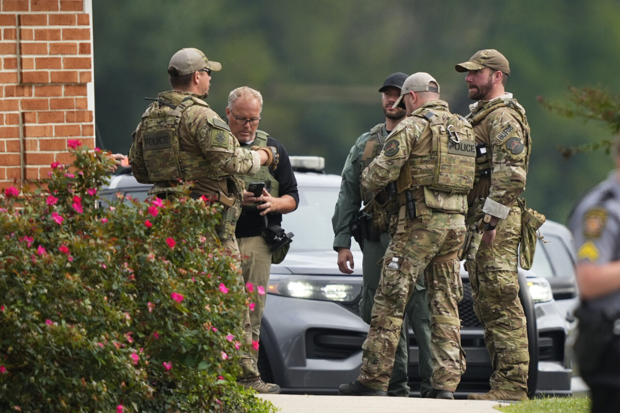 Law enforcement agents stand by as Danelo Souza Cavalcante sits inside an armored vehicle at the Pennsylvania State Police barracks at Avondale Pa., on Wednesday, Sept. 13, 2023. Cavalcante was captured Wednesday after eluding hundreds of searchers for two weeks. (AP Photo/Matt Rourke)