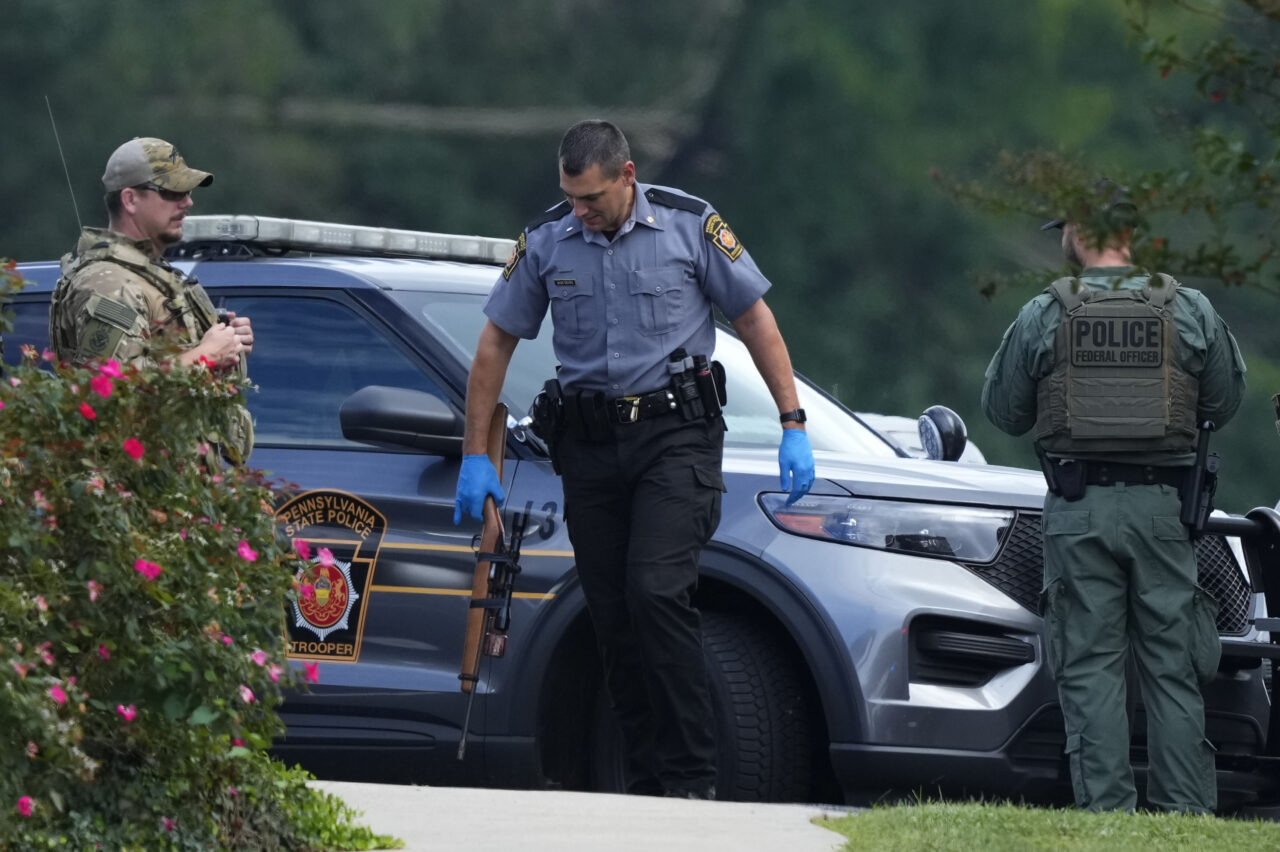 Law enforcement agents stand by as Danelo Souza Cavalcante sits inside an armored vehicle at the Pennsylvania State Police barracks at Avondale Pa., on Wednesday, Sept. 13, 2023. Cavalcante was captured Wednesday after eluding hundreds of searchers for two weeks. (AP Photo/Matt Rourke)