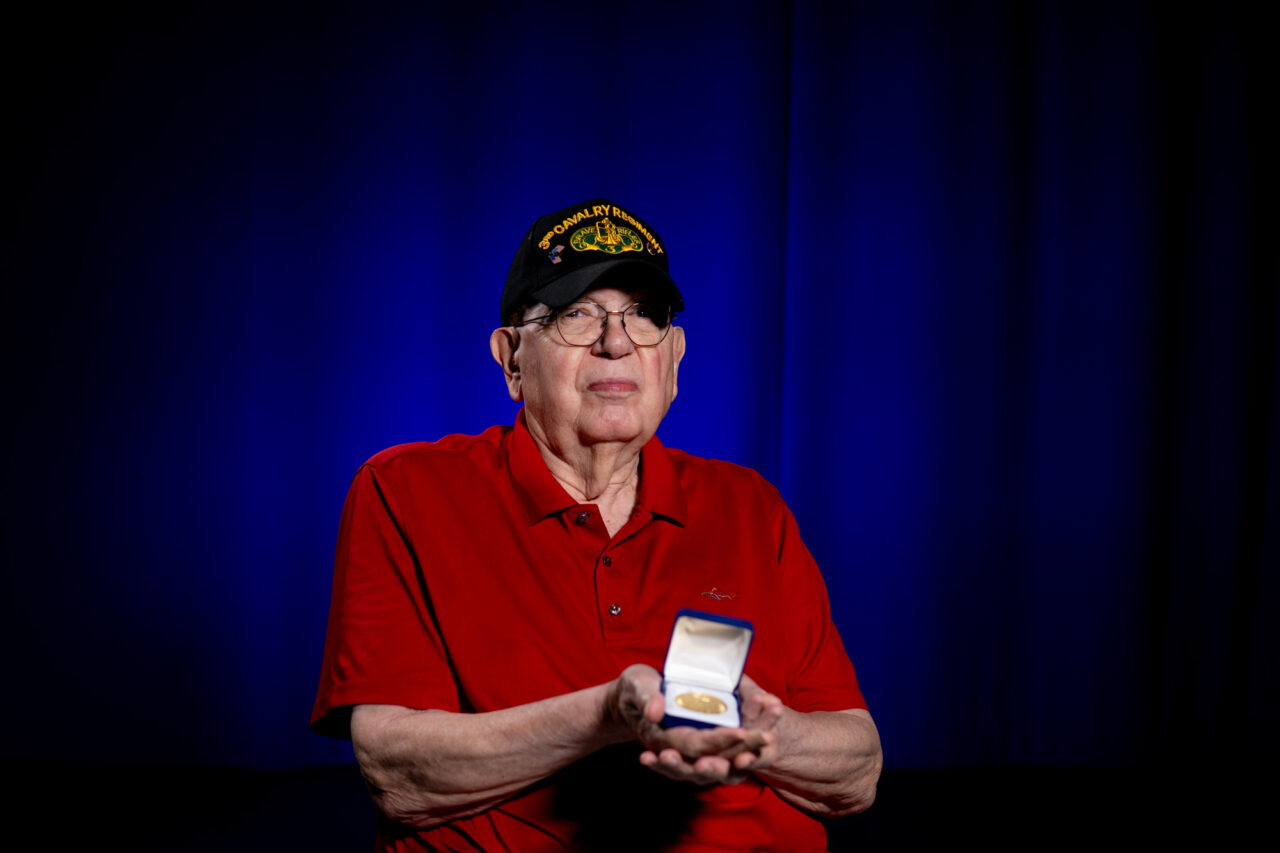 Tom Lambert holds his Atomic Veteran medal he received for taking part in Operation Grable.