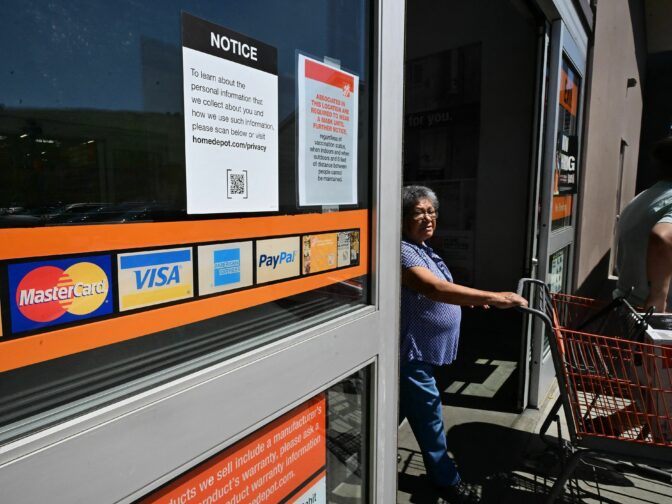 A display of credit cards accepted for use is seen on a door as a shopper steps out of a store on September 12, 2023 in Monterey Park, California. Credit card debt from US consumers is rising by billions of dollars amid higher inflation and interest rates, topping $1 trillion for the first time in history, according to the Federal Reserve Bank of New York. (Photo by Frederic J. BROWN / AFP) (Photo by FREDERIC J. BROWN/AFP via Getty Images)