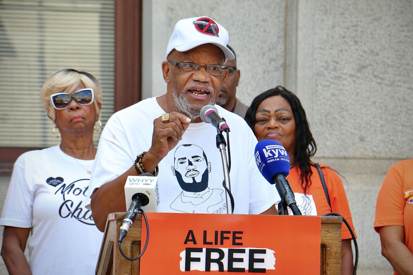 Stanley Crawford, the lead plaintiff in a lawsuit challenging Pennsylvania’s ban on local gun laws, speaks outside Philadelphia City Hall on the eve of the Supreme Court hearing that will decide whether his case goes forward. Crawford wears a shirt bearing a likeness of his son, who was shot to death in 2018. 

