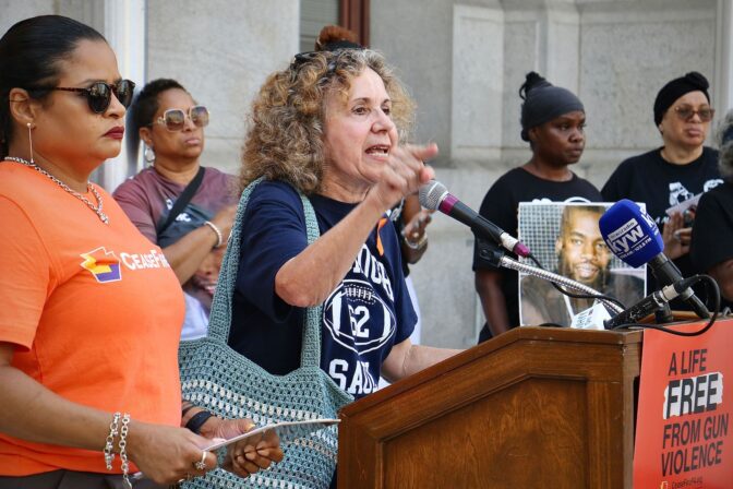 Marge LaRue, whose grandson was shot to death after a Roxborough High School football scrimmage last year, joins Mothers in Charge and Cease Fire PA, at a rally at City Hall. (Emma Lee/WHYY)