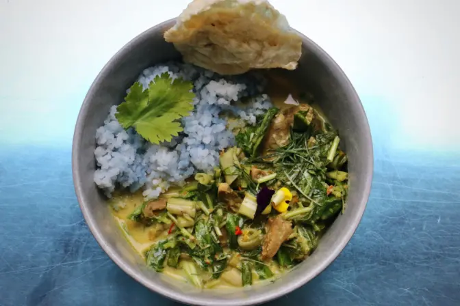 Chicken heart curry with blue rice prepared by chef Ange Branca
