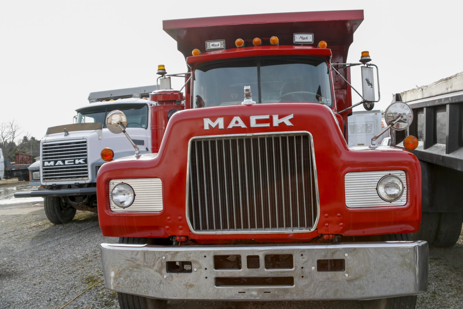 File - Used Mack trucks are parked on a lot in Evans City, Pa., on Jan. 9, 2020. Union workers at Mack Trucks have voted down a tentative five-year contract agreement reached with the company. 