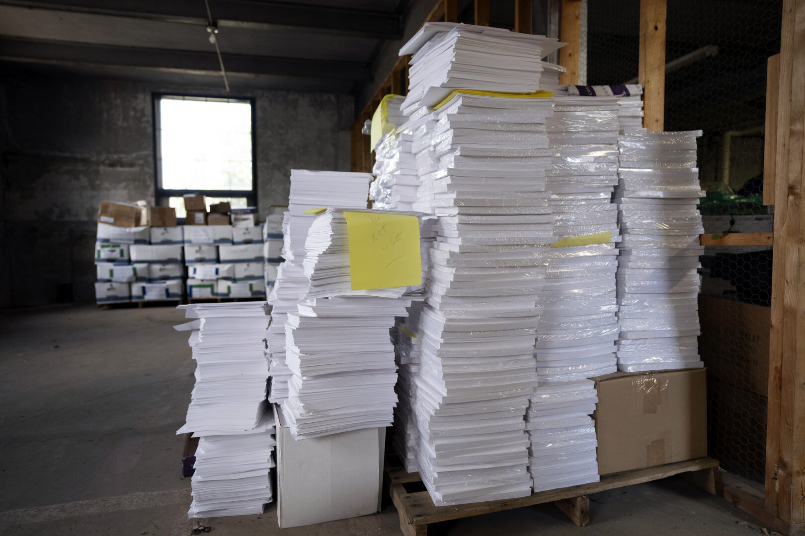 Stacks of paper too thick for Luzerne County's election equipment are seen in the county's warehouse in Wilkes-Barre, Pa., Wednesday, Sept. 13, 2023. 