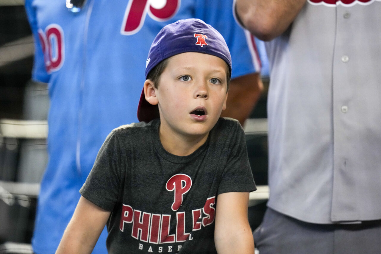 A Philadelphia Phillies fan watches batting practice before Game 4 of the baseball NL Championship Series against the Arizona Diamondbacks in Phoenix, Friday, Oct. 20, 2023. (AP Photo/Ross D. Franklin)