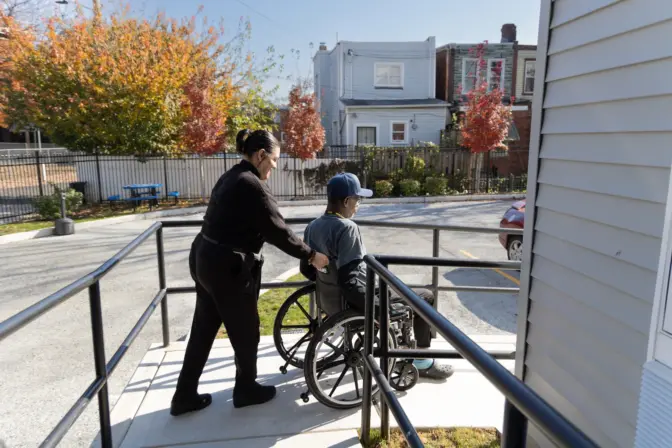 Vanessa Morbeck helps Leon Brantley, a fellow veteran, down the ramp at Veteran’s Village in Northeast Philadelphia.