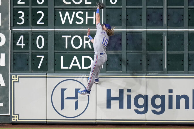 Texas Rangers outfielder Travis Jankowski makes a leaping catch against the Houston Astros.