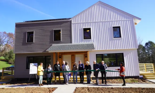 Local, county and state officials gather to cut the ribbon of a newly renovated 1970’s duplex in State College on Nov. 3, 2023.
