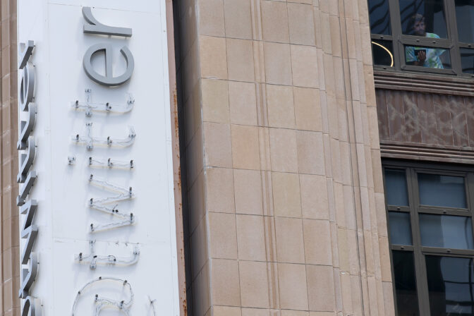 SAN FRANCISCO, CALIFORNIA - JULY 24: A building tenant looks out a window after letters were removed by workers from the Twitter sign that is posted on the exterior of Twitter headquarters on July 24, 2023 in San Francisco, California. Workers began removing the letters from the sign outside Twitter headquarters less than 24 hours after CEO Elon Musk officially rebranded Twitter as "X" and has changed its iconic bird logo, the biggest change he has made since taking over the social media platform. San Francisco police halted the sign removal shortly after it began. (Photo by Justin Sullivan/Getty Images)