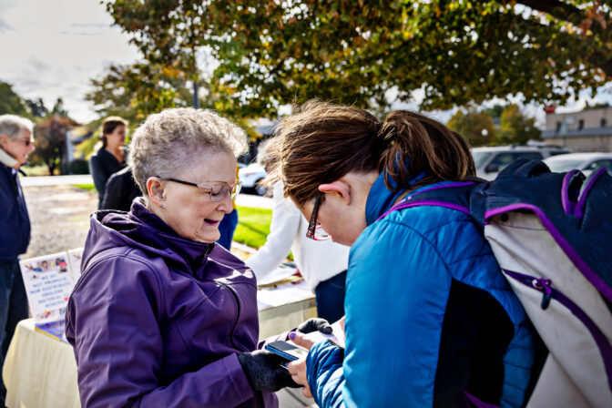 Volunteer Halli Stone, left, of Parents Against Bad Books convinces Samantha Neis to sign a petition while protesting obscene literature being available at the public library outside of Idaho Falls Public Library on Wed., October 4, 2023, in Idaho Falls, ID.