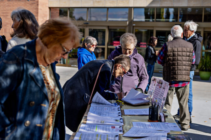 Volunteer Halli Stone, right, of Parents Against Bad Books talks with Donna Park as she signs a petition while protesting obscene literature being available at the public library outside of Idaho Falls Public Library on Wed., October 4, 2023, in Idaho Falls, ID.