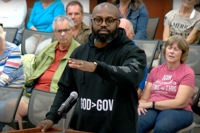 Pastor John K. Amanchukwu speaks at an August school board meeting in Indian River County, Fla. He was just a few words into reading an explicit passage from the book 13 Reasons Why when he was cut off by the board chair — triggering the book's automatic removal from the school library.