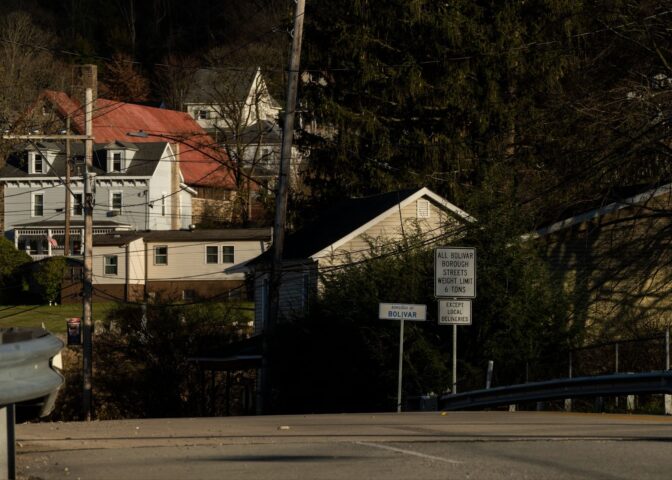 A sign greets drivers to Bolivar, Pennsylvania, with local homes in the background. It is the home of FAVOR ~ Western PA, which provides syringe services.