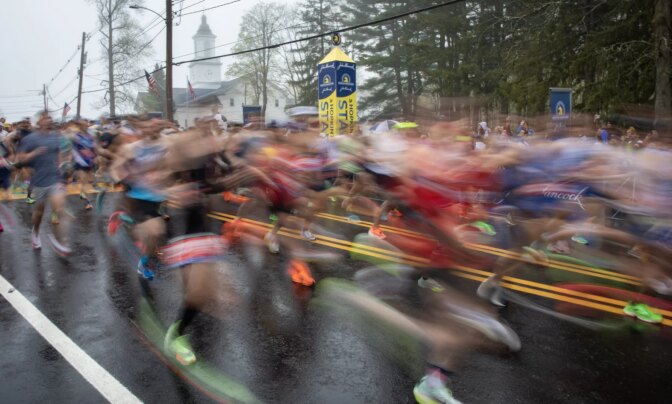 Runners cross the starting line of the 127th Boston Marathon. (Robin Lubbock/WBUR)