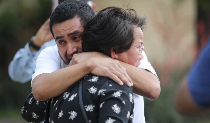 Victor Ramirez hugs Gina Bennett, both work at the mall, at the memorial for the victims of Saturday’s shooting Monday, May 8, 2023, at Allen Premium Outlets in Allen. Eight people were killed when 33-year-old Mauricio Garcia opened fire at the mall. Five others remain hospitalized, three in critical condition.