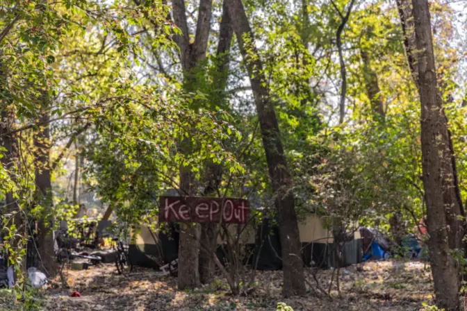 People experiencing homelessness in Pottstown, Pa., camped by the Schuylkill River in November of 2023. (Kimberly Paynter/WHYY)