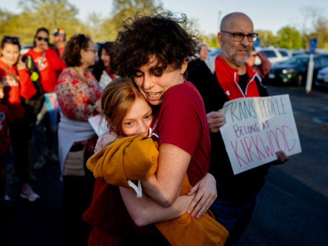 Hollis Moore, a 30-year-old teacher in the Kirkwood School District, hugs their student Maggie McCoy, 10, on Monday, April 17, 2023, before a school board meeting outside North Kirkwood Middle School in Kirkwood. Moore alleges they have been discriminated against by district officials due to their gender identity.