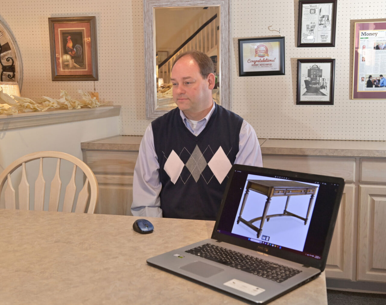 Dave Moyer, third generation owner of Benjamin T. Moyer Furniture in Sunbury, speaks with a reporter about purchases made from his story by Governor Josh Shapiro on Thursday, Nov. 16, 2023. The desk on the laptop photo is like a desk recently purchased by Shapiro earlier this year..