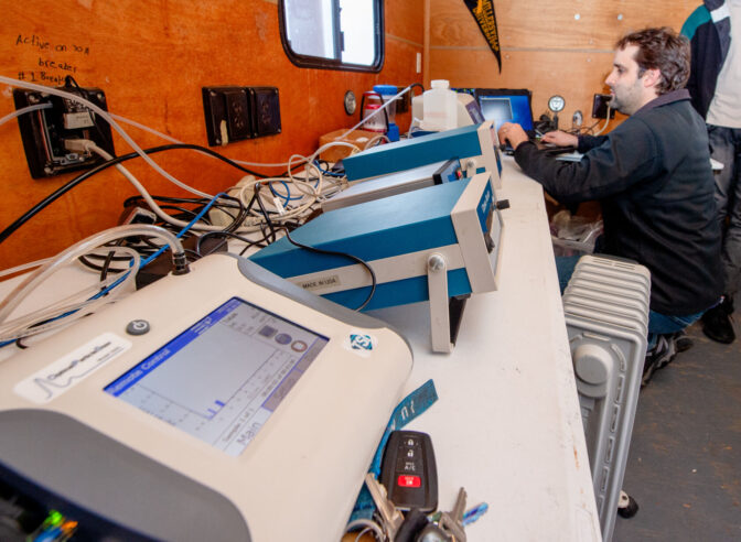 Greg Blumberg, assistant professor of meteorology at Millersville University, checks data collection inside the Air Quality Monitoring Station for Millersville Atmospheric Research and Aerostat Facility on Monday, Dec. 4, 2023. The monitoring station is a trailer, and is parked behind the Farm & Home Center 1383 Arcadia Road to monitor air quality from Rt. 30 which runs behind the Farm & Home Center.