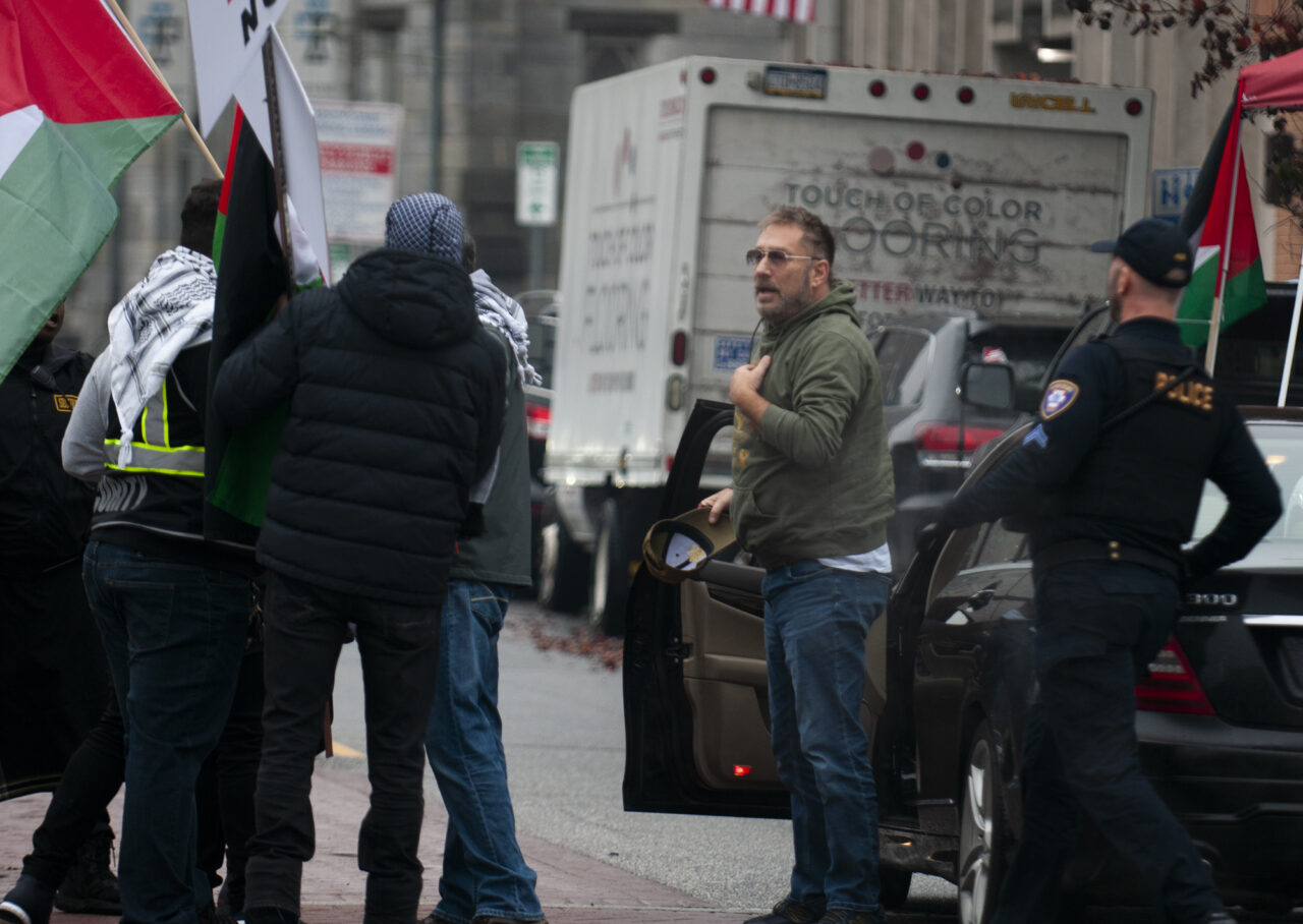 A man who waved an Israel flag and had it taken from him confronts hundreds gathered at the state capitol building in Harrisburg on Dec. 10, 2023 calling for a permanent cease fire in the war between Israel and Palestine. Jeremy Long - WITF