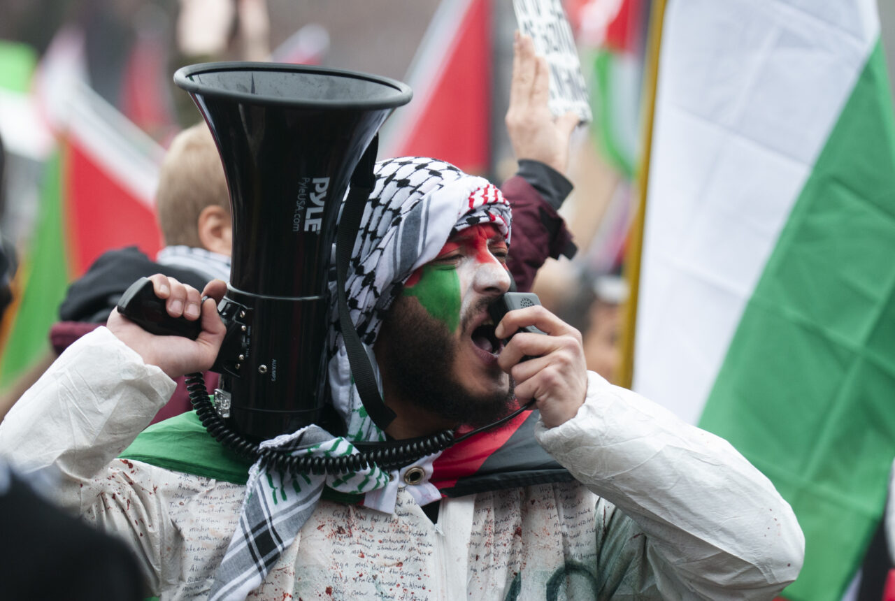 A man shouts into a megaphone outside of the governor's residence as hundreds gathered at the state capitol building and marched to the governor's residence in Harrisburg on Dec. 10, 2023 calling for a permanent cease fire in the war between Israel and Palestine. Jeremy Long - WITF