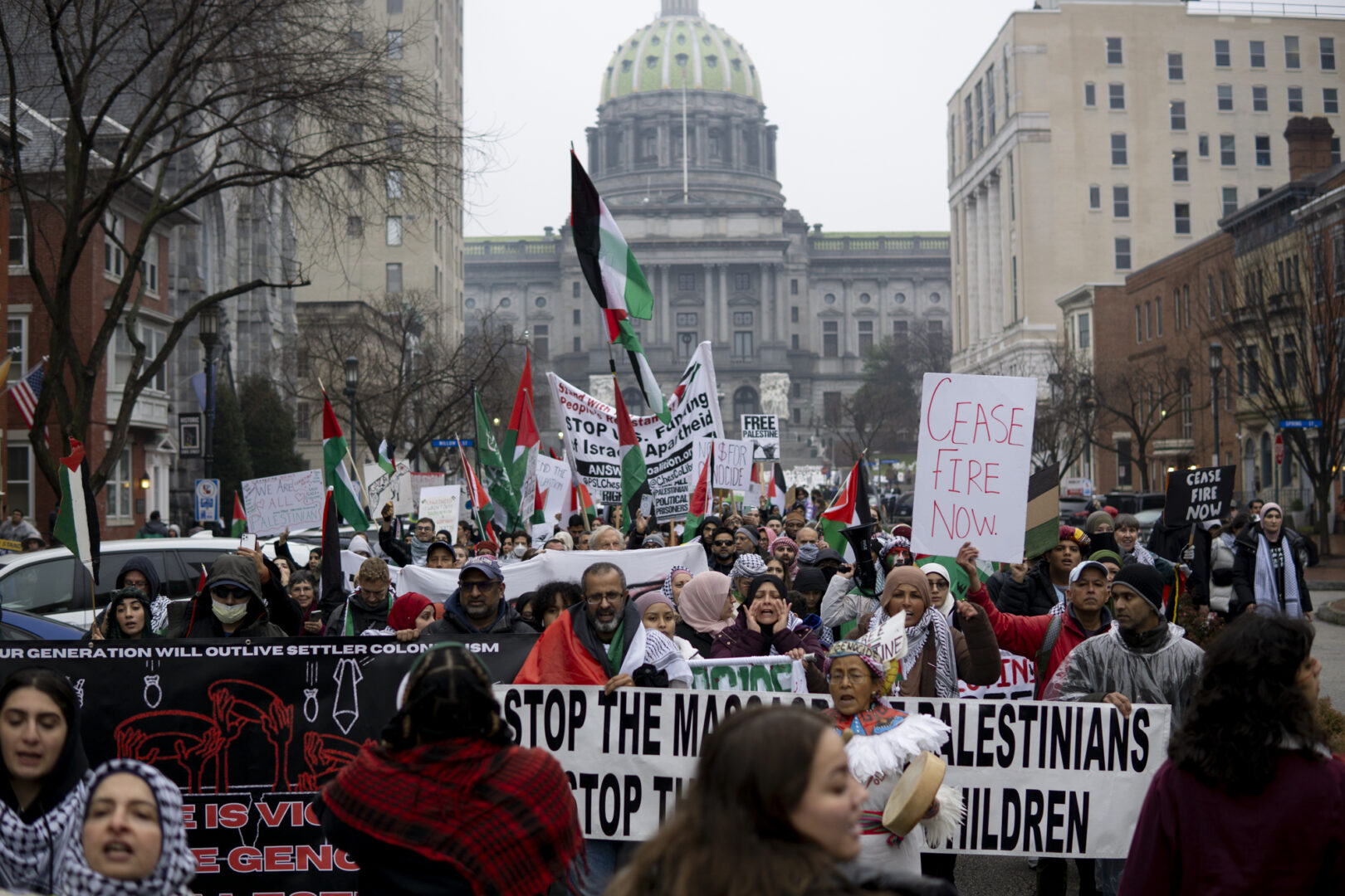 Demonstrators march down State Street as hundreds gathered at the state capitol building and marched to the governor's residence in Harrisburg on Dec. 10, 2023 calling for a permanent cease fire in the war between Israel and Palestine. Jeremy Long - WITF