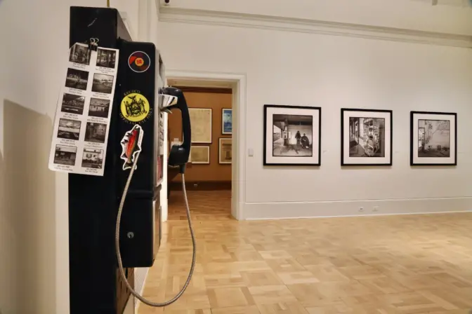 There are two payphones in ”Life-Lines Throughout the United States,” an exhibit at the Maguire Museum at Saint Joseph’s University. Through them, visitors can hear the artist, Eric Kunsman, talking about his work, or hear from people who still rely on the antiquated technology. (Emma Lee/WHYY)